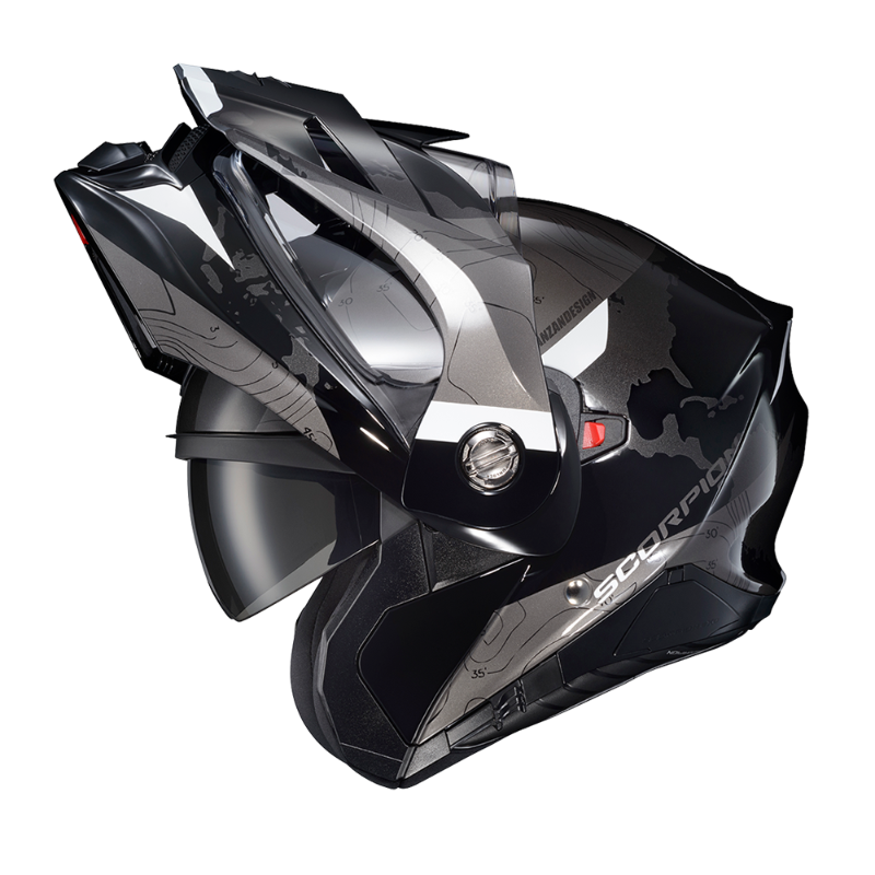 Scorpion EXO-AT960 Topographic Modular Adventure Motorcycle Helmet in Black/White shown with the modular chin bar in the fully raised position. The helmet features a matte black and grey topographic map graphic with white accent panels, a clear EverClear® face shield, integrated drop-down SpeedView® sun visor, and aerodynamic adventure peak visor. The open modular design demonstrates the helmet's convenient flip-up functionality for easier communication, fueling, and added comfort when stopped, while mainta
