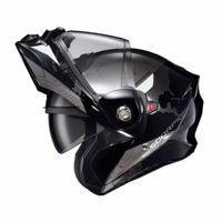 Side profile of the Scorpion EXO-AT960 Topographic Modular Adventure Motorcycle Helmet in Black/White with the modular chin bar in the fully raised position. The helmet features a matte black and metallic grey shell with topographic map graphics and white accent panels. Visible are the clear EverClear® face shield, integrated SpeedView® drop-down sun visor, and the convenient flip-up chin bar that allows easy communication, fueling, and improved comfort when stopped. Designed for adventure touring and dual-