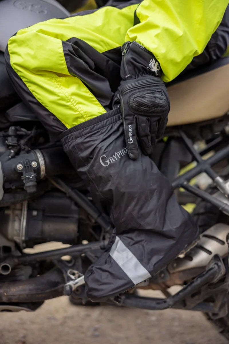 Gryphon branded black motorcycle gaiter on a motorcycle rider sitting on a motorcycle