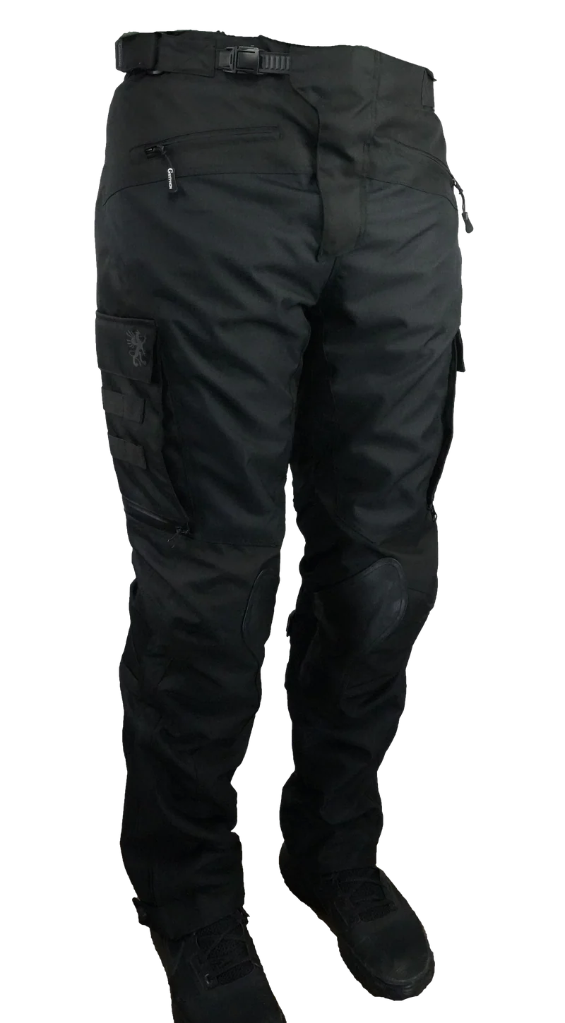 Front view of Gryphon Single Track Waterproof Motorcycle Pants in black. These adventure riding pants feature a durable textile construction, adjustable waist buckle, zippered front pocket, cargo pocket with Gryphon logo, reinforced knee panels with CE armour pockets, and a slim articulated fit designed for touring, dual-sport, and off-road motorcycle riding.