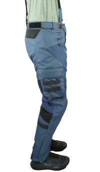 Right-side view of Gryphon Single Track Waterproof Motorcycle Pants in blue. These adventure riding pants feature a durable waterproof textile construction, removable suspenders, adjustable waist buckle, zippered hand pocket, large cargo pocket with MOLLE webbing and Gryphon logo, reinforced knee panels, articulated fit for riding comfort, and zippered lower leg openings for easy boot access. Designed for touring, dual-sport, and off-road motorcycle adventures in all weather conditions.