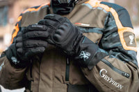 Person wearing a brown jacket and Gryphon Tofino cold Weather black motorcycle gloves with Gryphon branding.