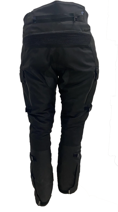 Gryphon Women’s Pacific Coast 2 black waterproof motorcycle pants with zippered rear vent, stretch waist panel and adjustable lower legs, back view.