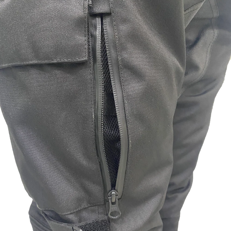 Close-up of the zippered rear mesh ventilation panel and adjustable knee strap on Gryphon Women’s Pacific Coast 2 waterproof motorcycle pants.