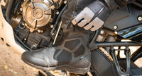 Joe Rocket Alter Ego 2.0 Waterproof Touring Motorcycle Boots worn beside an adventure motorcycle, showcasing the lightweight waterproof design, reinforced ankle and toe protection, secure closure system, and all-day comfort for touring, commuting, and sport-touring motorcycle riding.