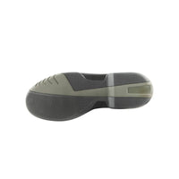Side view of a green and black shoe sole on a white background