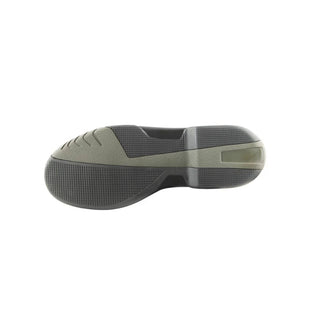 Side view of a green and black shoe sole on a white background