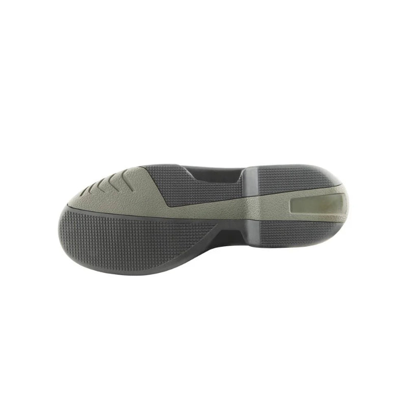Side view of a green and black shoe sole on a white background