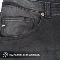 Close-up of dark gray jeans with a brand label and text indicating denim frame details.