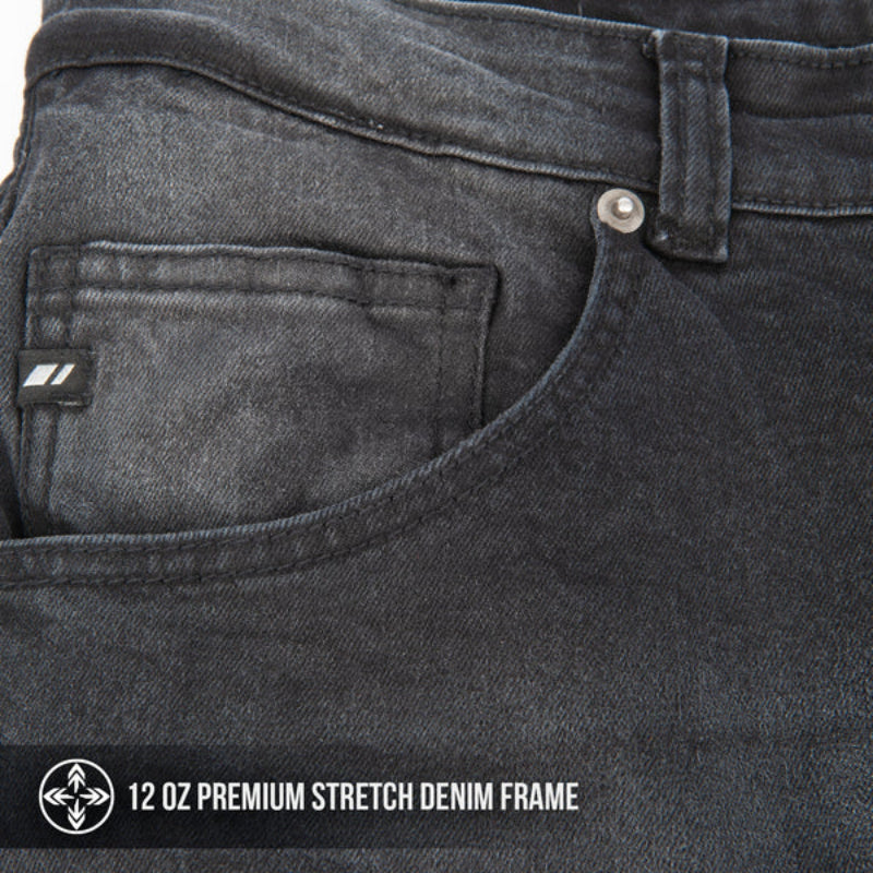 Close-up of dark gray jeans with a brand label and text indicating denim frame details.