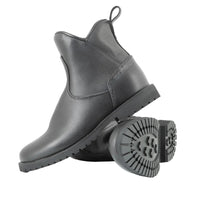 A pair of black leather Chelsea-style ankle boots with chunky lug soles, shown on a clean white background. One boot is standing upright, and the other is lying on its side to display the tread pattern of the sole.