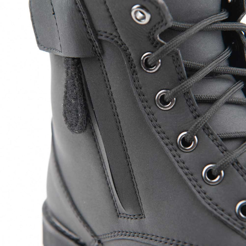Close-up of the Joe Rocket Iron Age Waterproof Motorcycle Cruiser Boot highlighting the convenient side zipper with hook-and-loop retention strap for easy on and off. The durable black leather construction, classic lace-up design, and waterproof build provide comfort, protection, and convenience for cruiser, touring, and everyday motorcycle riding.