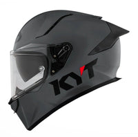 Grey motorcycle helmet with clear visor on a white background