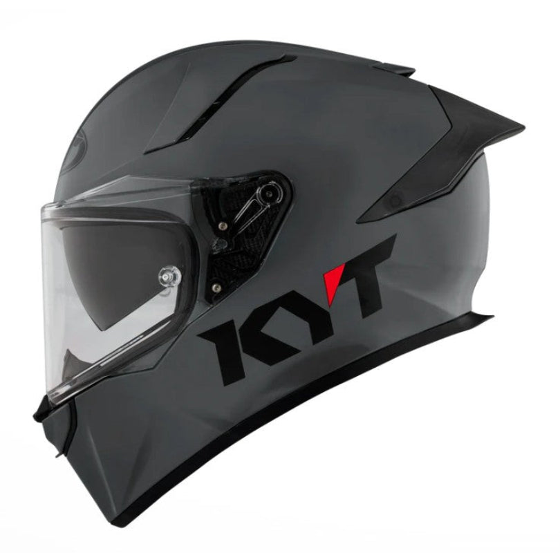 Grey motorcycle helmet with clear visor on a white background