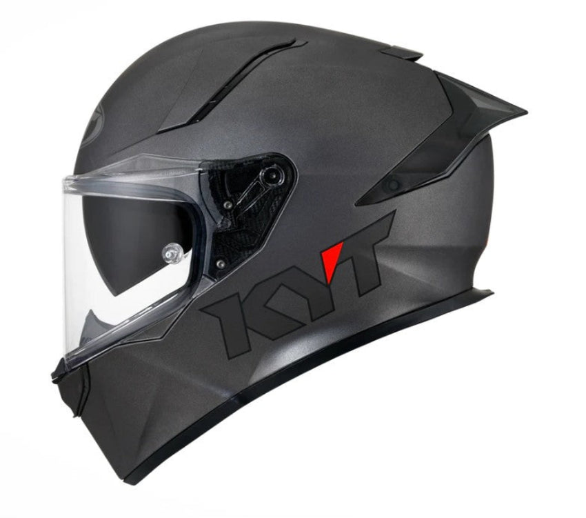 Gunmetal grey motorcycle helmet with clear visor on a white background