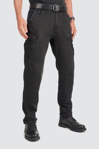 Person wearing black motorcycle cargo pants on a white background