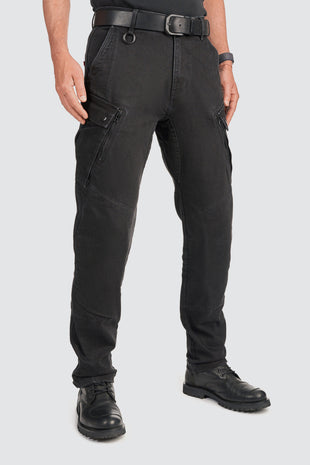 Person wearing black motorcycle cargo pants on a white background