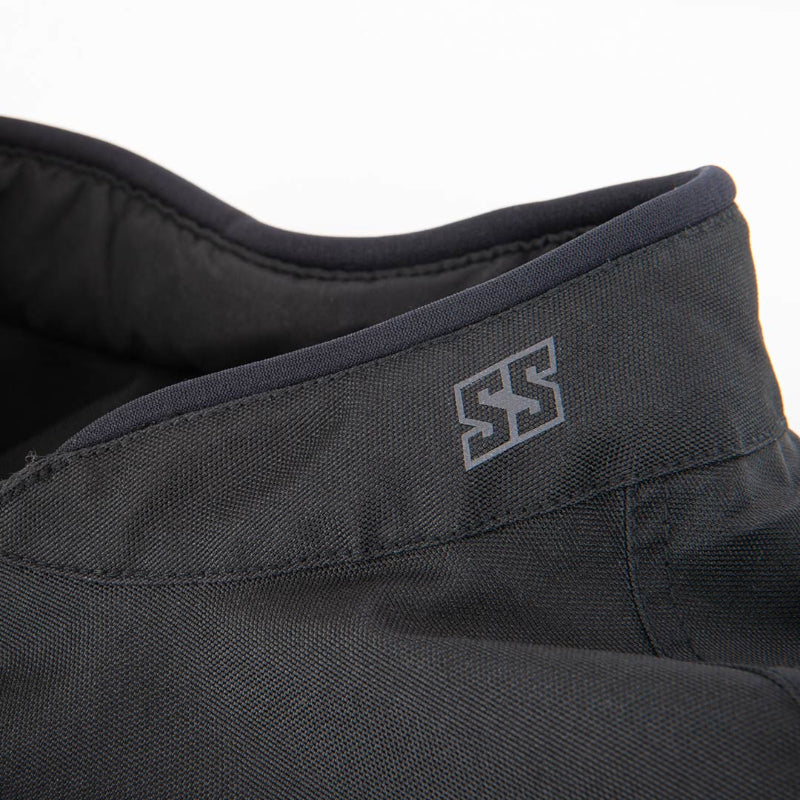 Close-up of a dark gray or black textured fabric garment, showing a collar with a stitched gray double-S logo and a dark interior lining.