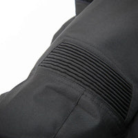 Close-up detail of a black technical jacket showing a ribbed pleated pocket on a white background.