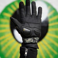 Close-up of MotoGirl Bessie black leather motorcycle glove showing palm-side construction, protective palm sliders and camouflage adjustable wrist strap.