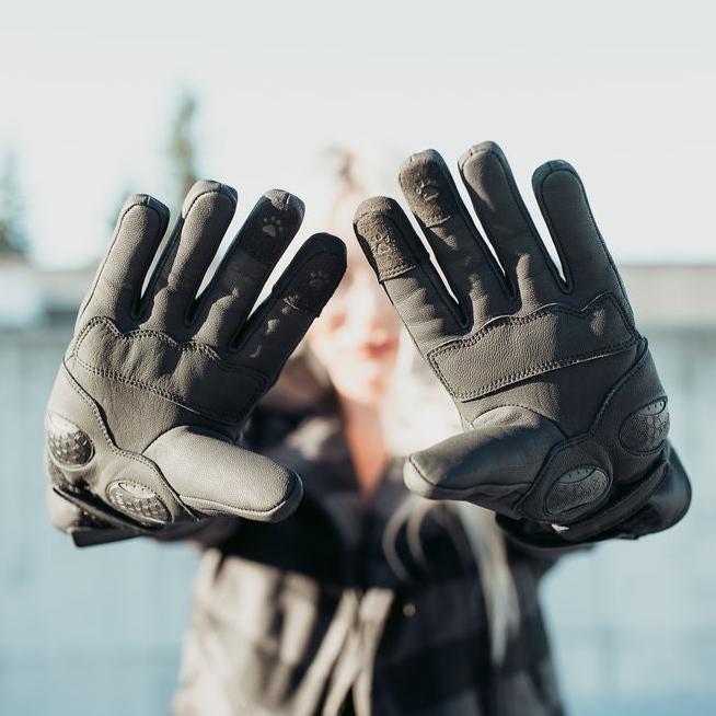 A person wearing Motogirl Nandi Winter Motorcycle gloves in black showing palm protection