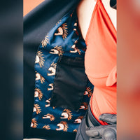 Interior view of the MotoGirl Sherrie black motorcycle jacket showing the inside pocket and colourful patterned lining.