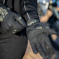Motogirl branded black with camo print  around wrist Bessie motorcycle gloves featuring knuckle protection and brand logo on the wrist.