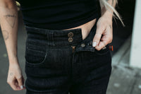 A girl wearing a black shirt shoring the zipper and snaps for the Motogirl Ellie Motorcycle Jeans in Blue