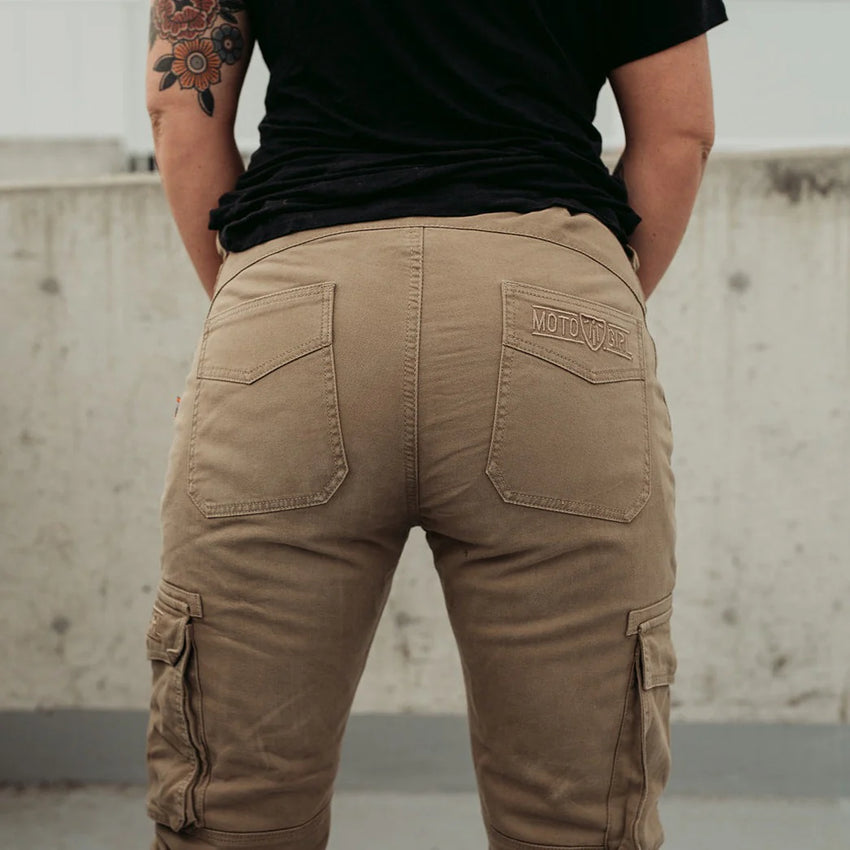 Person wearing brown cargo pants with a visible brand logo, standing against a neutral background.