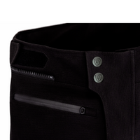 Close-up of the MotoGirl Vanessa Women's Motorcycle Pants waistband showing the secure dual-snap front closure, hook-and-loop waist adjustment, and waterproof zippered front pockets. The durable black textile construction provides a comfortable, adjustable fit for touring, adventure, and everyday motorcycle riding.