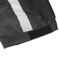 Close-up of the Nelson-Rigg STORMRIDER motorcycle rain jacket sleeve featuring an adjustable hook-and-loop (Velcro) cuff closure, elastic wrist, and wide reflective strip for a secure, weatherproof fit and enhanced rider visibility in low-light conditions.
