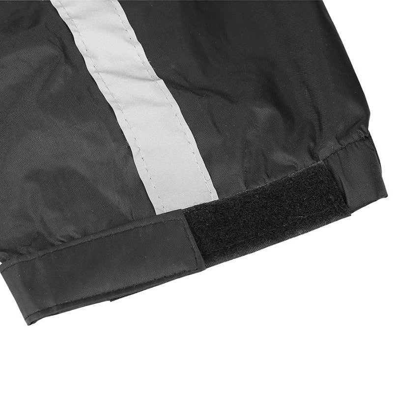 Close-up of the Nelson-Rigg STORMRIDER motorcycle rain jacket sleeve featuring an adjustable hook-and-loop (Velcro) cuff closure, elastic wrist, and wide reflective strip for a secure, weatherproof fit and enhanced rider visibility in low-light conditions.