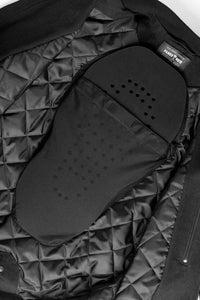 Close-up of a black quilted jacket with motorcycle protective pad in lining.