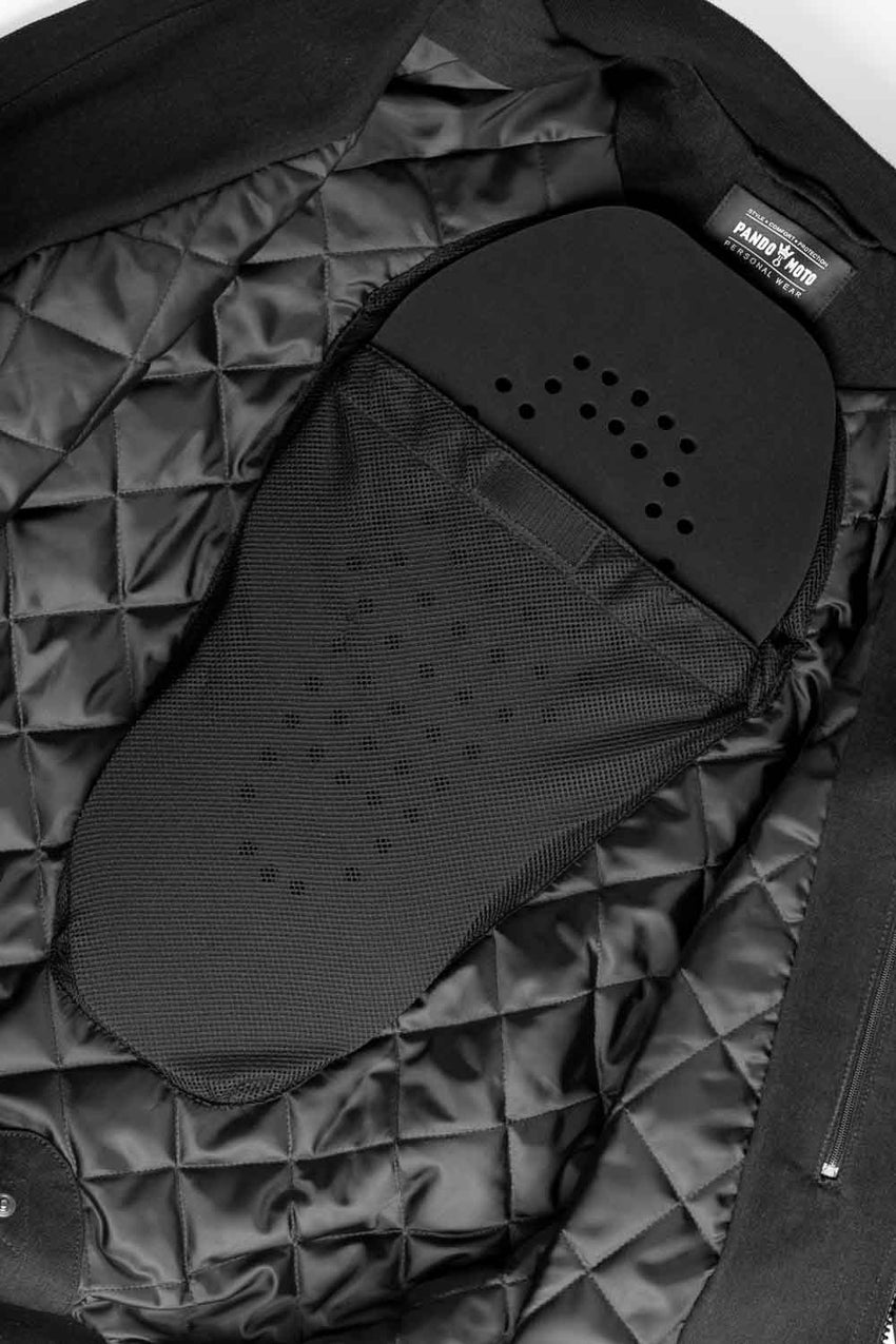 Close-up of a black quilted jacket with motorcycle protective pad in lining.