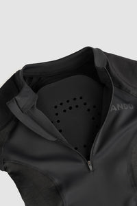 A black Pando Moto Shell ww inside showing where optional back protection would go on a grey background.