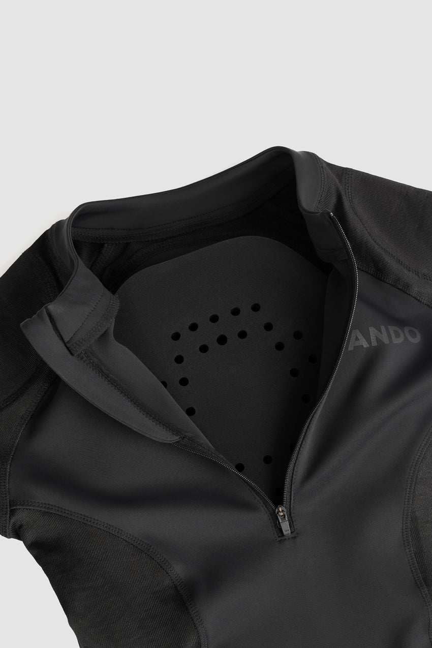 A black Pando Moto Shell ww inside showing where optional back protection would go on a grey background.