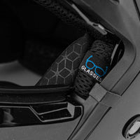 Close-up of a black helmet with a strap featuring '6D Glasses' branding.