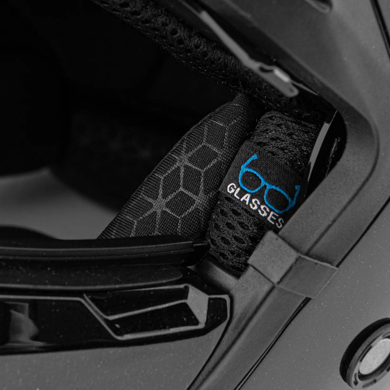 Close-up of a black helmet with a strap featuring '6D Glasses' branding.