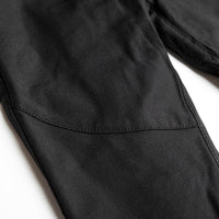 Close-up of a black motorcycle pants stitching on a white background