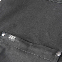 Close-up of a black fabric with a brand label on a pocket