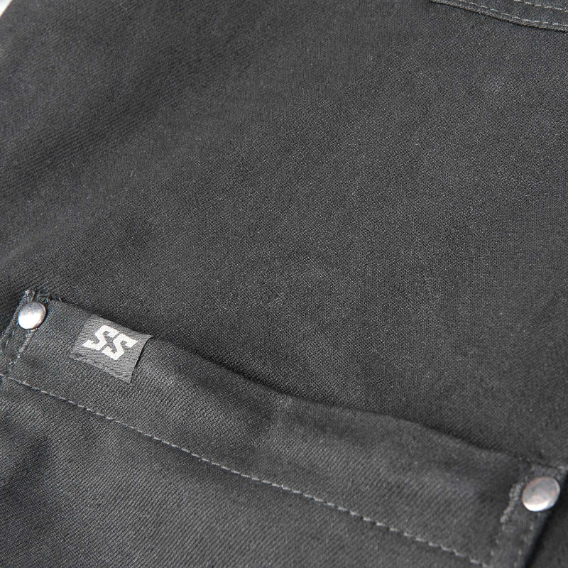 Close-up of a black fabric with a brand label on a pocket