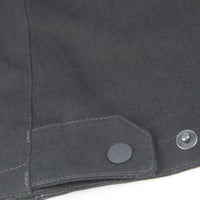 Close-up of a dark gray fabric with buttons on a white background