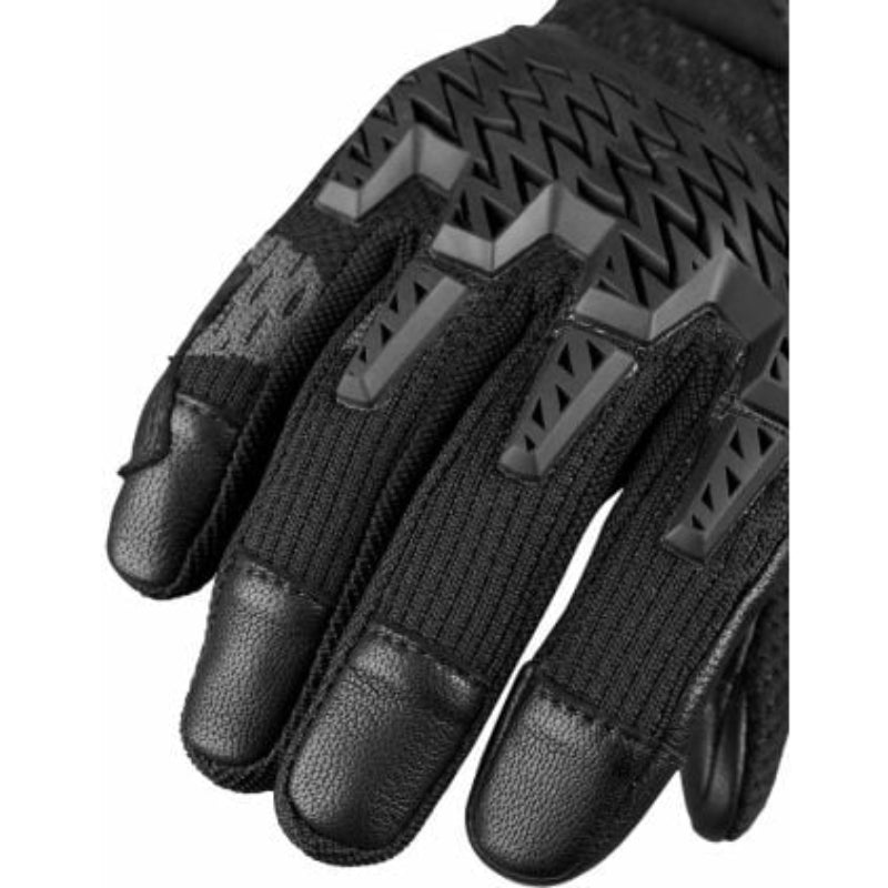 Black tactical glove with textured palm and finger details on a white background
