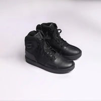 A pair of black high-top motorcycle riding shoes with lace closure and rubber sole.