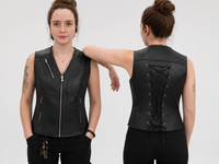 Woman modelling a black leather motorcycle vest, shown from the front and back, featuring silver zippered pockets and an adjustable lace-up back.