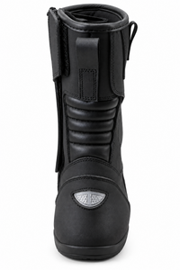 A black leather motorcycle boot shown from the front on a white background, featuring a protective toe cap with a silver shield logo.