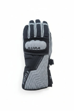 Gray and black glove with 'Aura' branding on a wooden surface