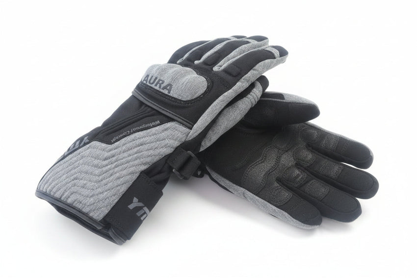 Pair of gray and black gloves on a wooden surface