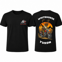 Front and back of a black YMGA Whitehorse Yukon T-shirt featuring a caribou in sunglasses riding a red cruiser motorcycle at sunset.