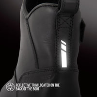 Close-up of a black ankle boot showing a reflective vertical trim on the back panel, with text reading 'REFLECTIVE TRIM LOCATED ON THE BACK OF THE BOOT'.